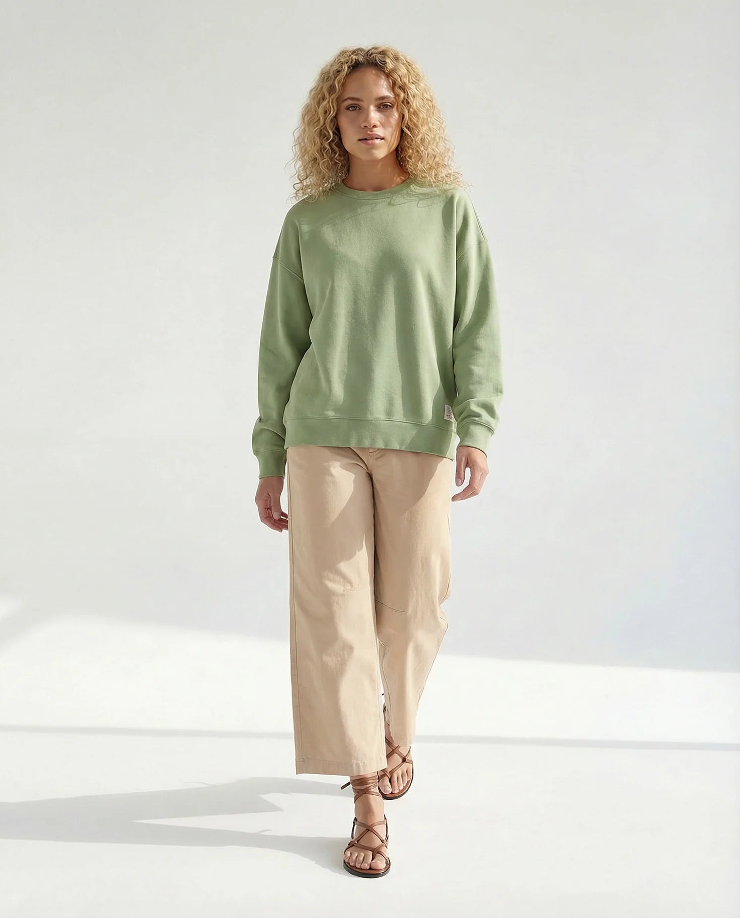 Tessa Patch Sweatshirt YOU TOO in Sage Green, oversized Schnitt mit langen Ärmeln, kombiniert mit weiter beiger Hose #farbe_pesto